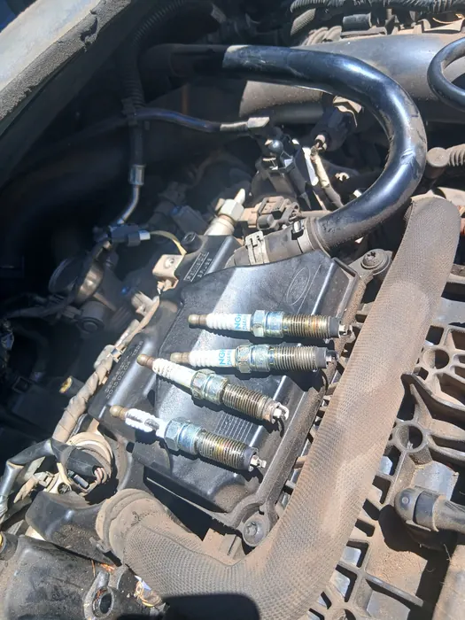 Spark plugs lifted out of an engine
